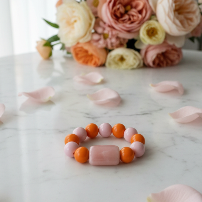 Colorful Chica Chica Jewelry Blush & Citrus Color Pop Bracelet - beaded bracelet on a marble surface with flowers in the background