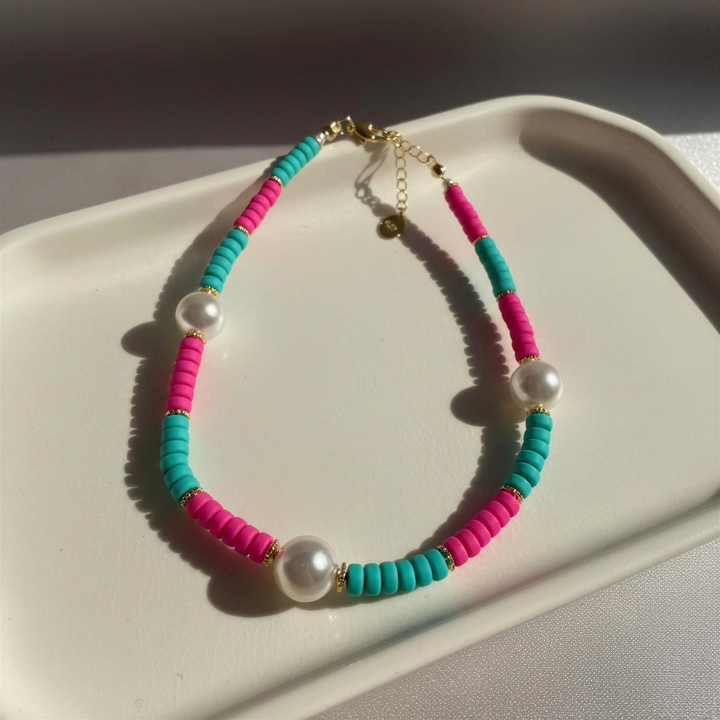 Colorful beaded bracelet with pearls on a white surface