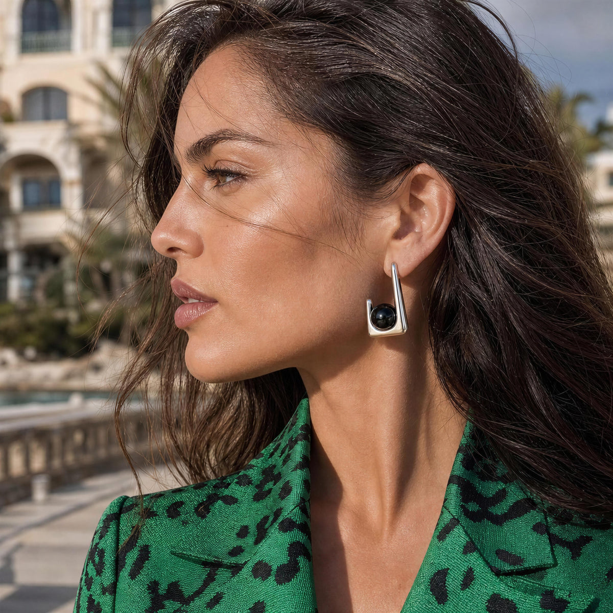 Model wearing Kara silver-tone geometric earrings with black agate accents.