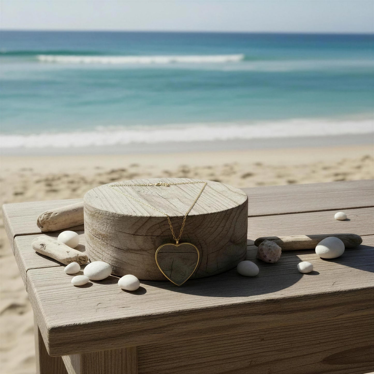 Wooden box with the Cristallo Heart Necklace on a wooden surface by the beach.