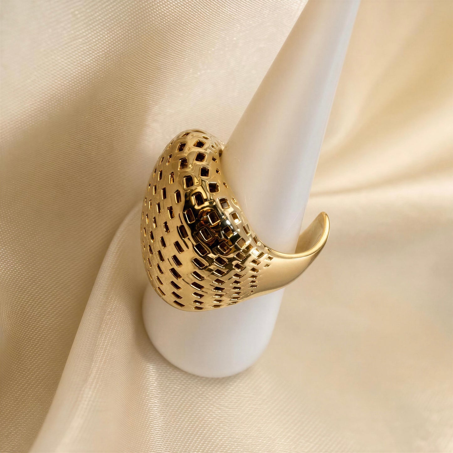 The Chica_Chica_Jewelry Trama_Ring, displayed on a white cone stand against a draped cream fabric background.