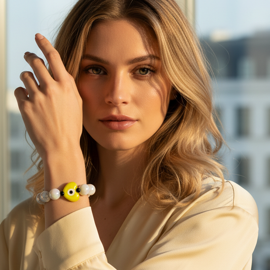 Woman wearing the Aegis Sol Heart Bracelet  in front of a window