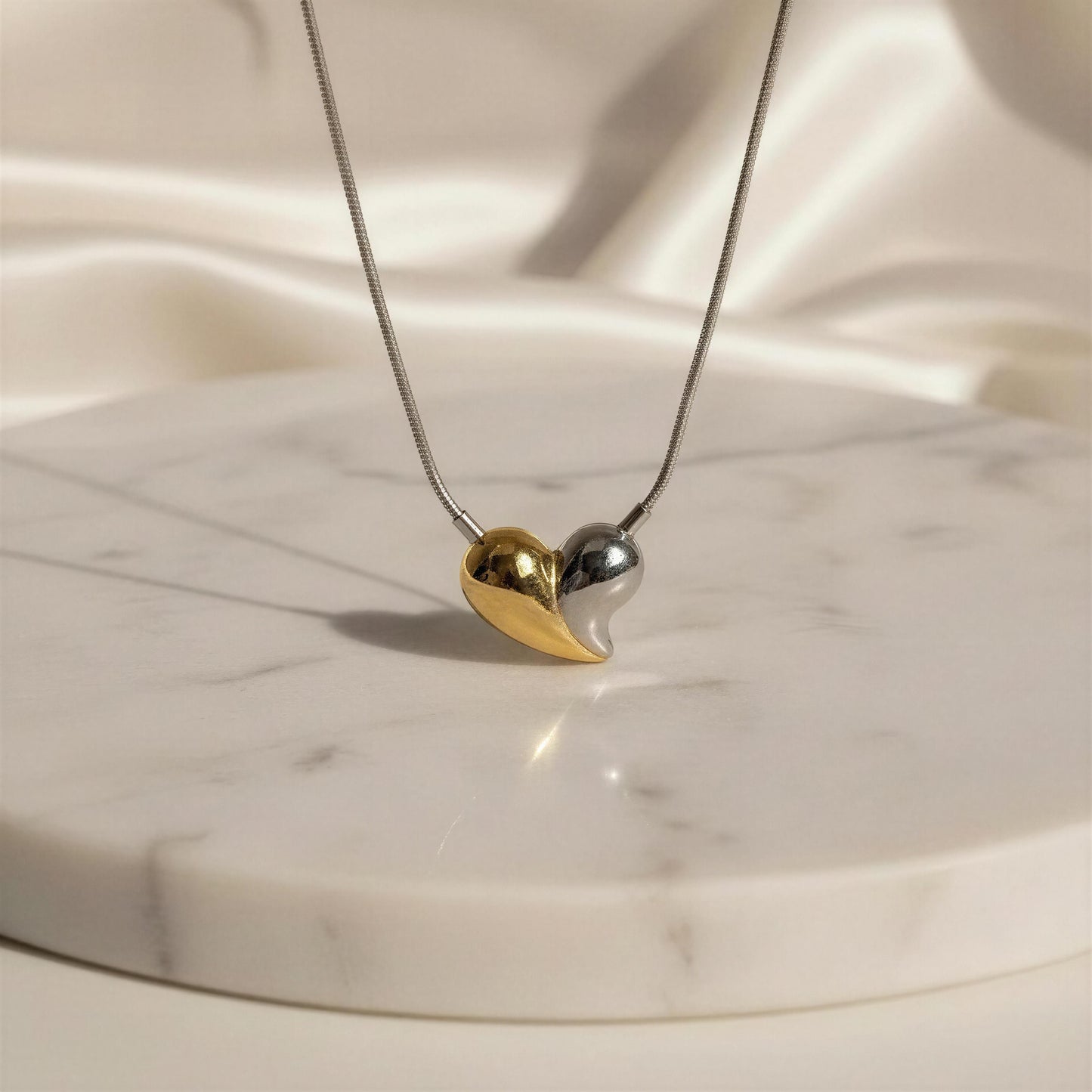Necklace with a heart-shaped pendant on a marble surface
