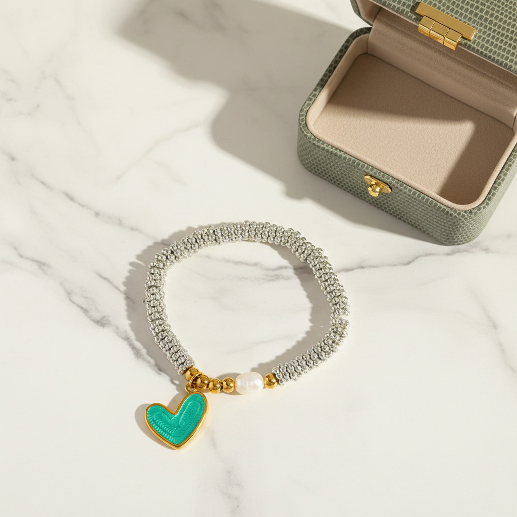 Flatlay of the Endless_Promise_Mint_Heart_Bracelet_CC_Jewelry on a marble table with a shagreen small jewelry box