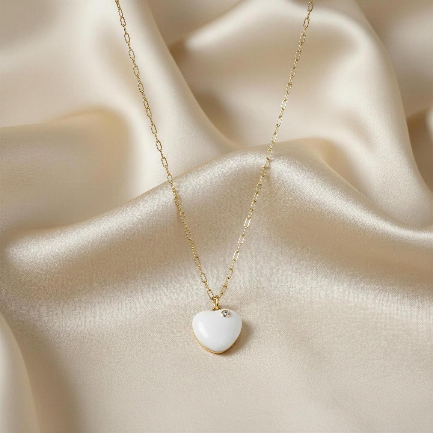Necklace with a heart-shaped pendant on a beige fabric background