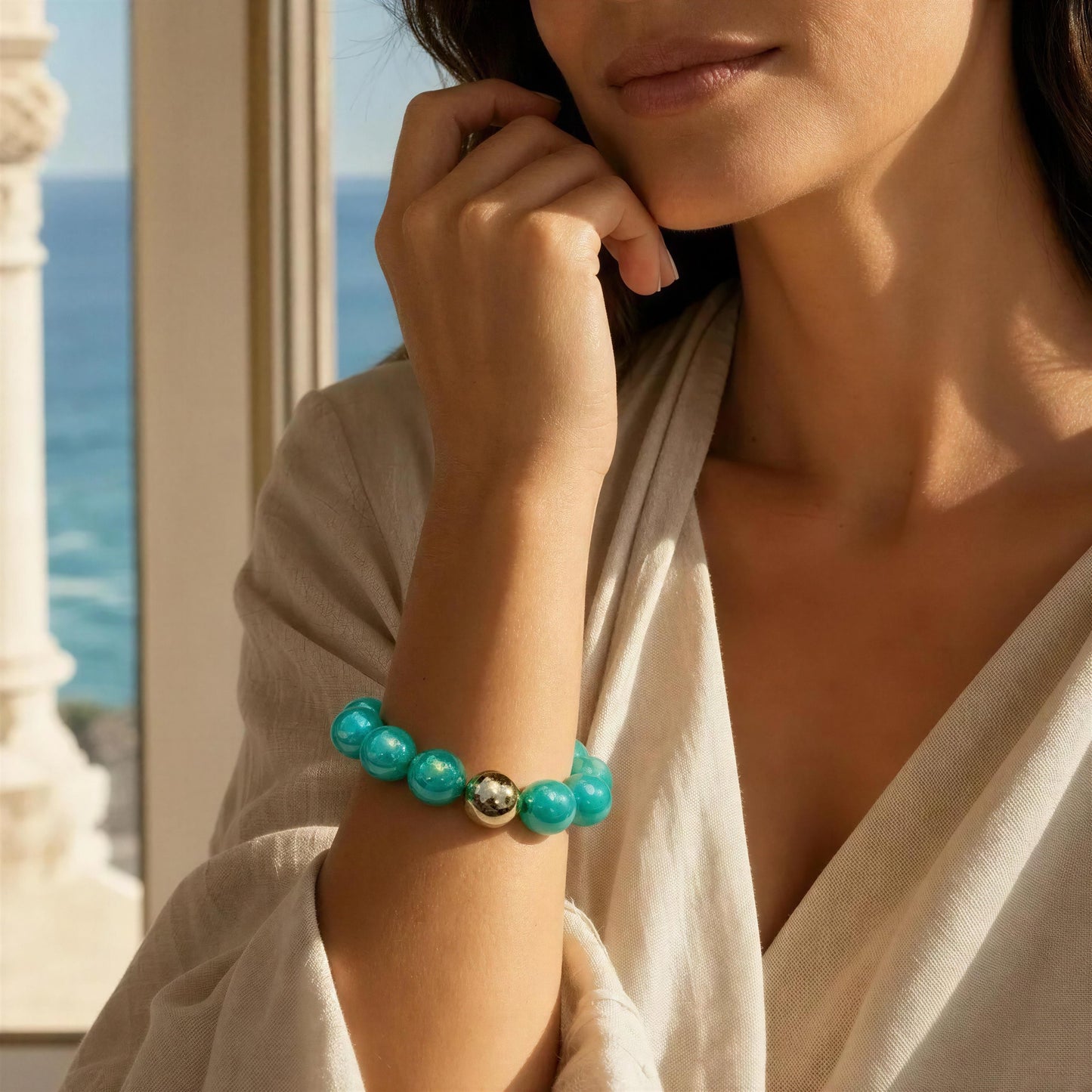 Woman wearing a turquoise beaded bracelet with a scenic background