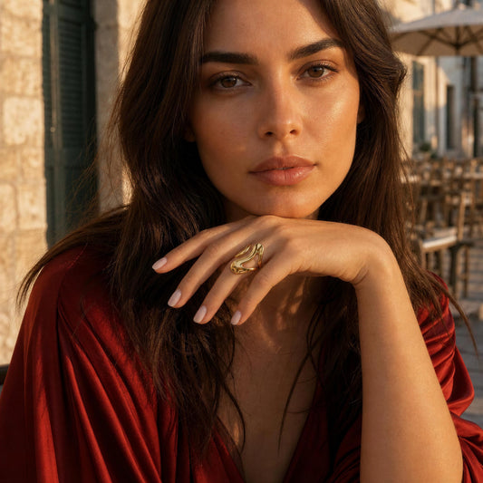 Model wearing the Áurea Ring from Chica Chica Jewelry, dressed in red silk dress. 