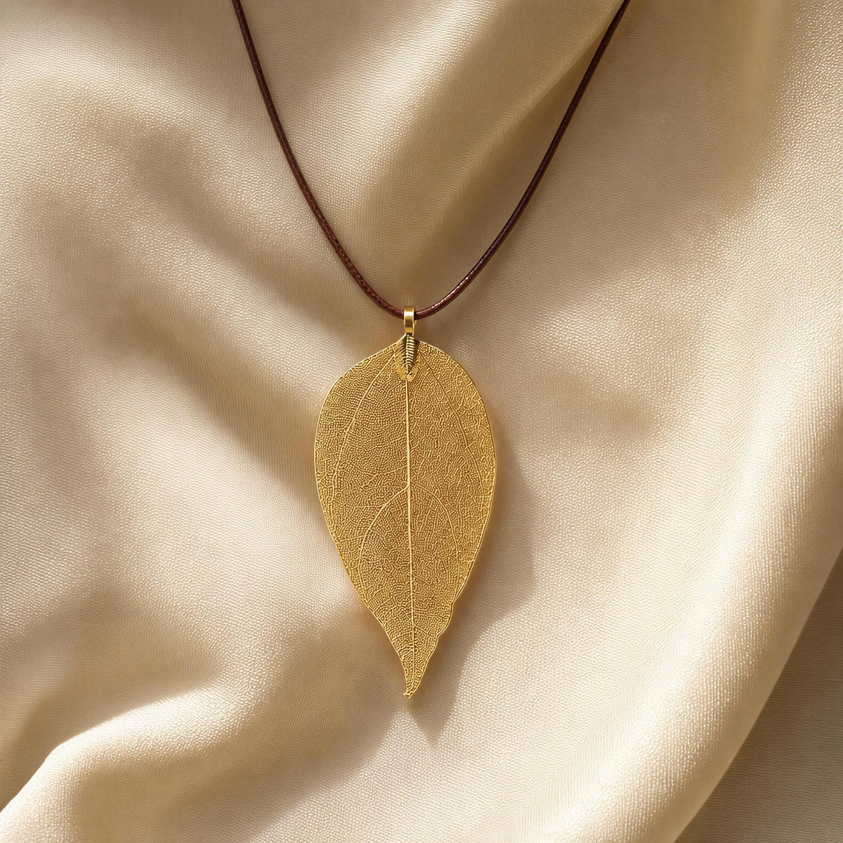 The Aurelia Necklace from  Chica Chica Jewelry against a creme color  fabric. 