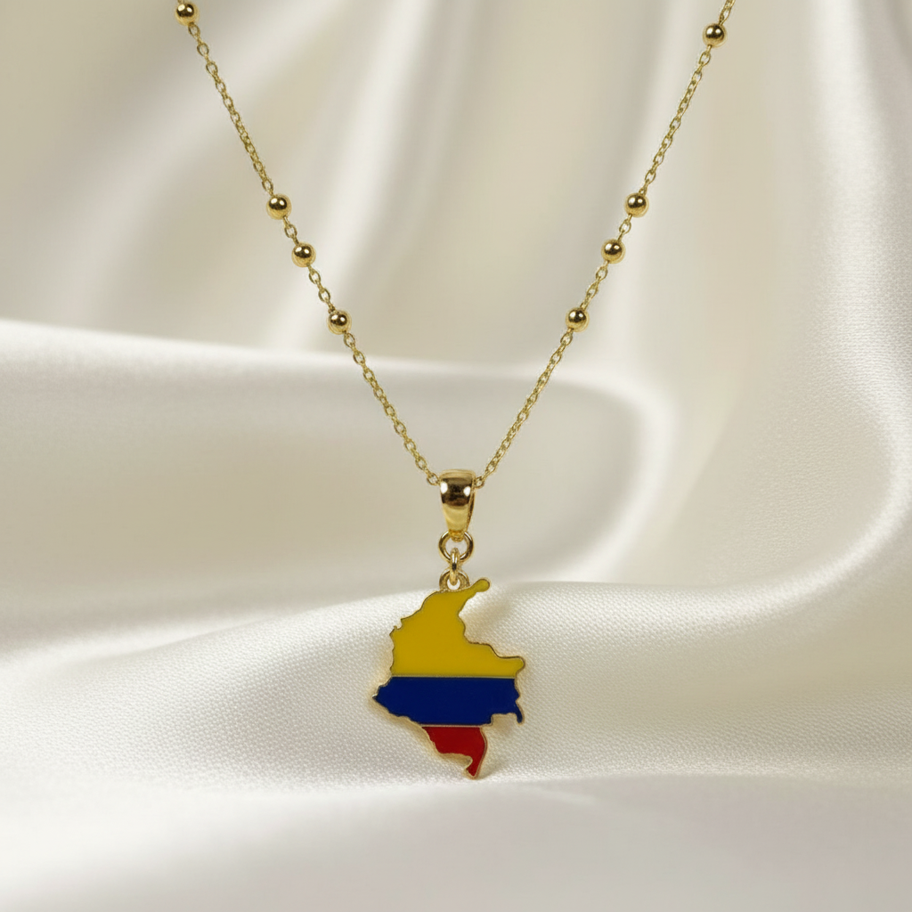 The Bacatá Necklace with a pendant shaped like the map of Colombia on a white fabric background