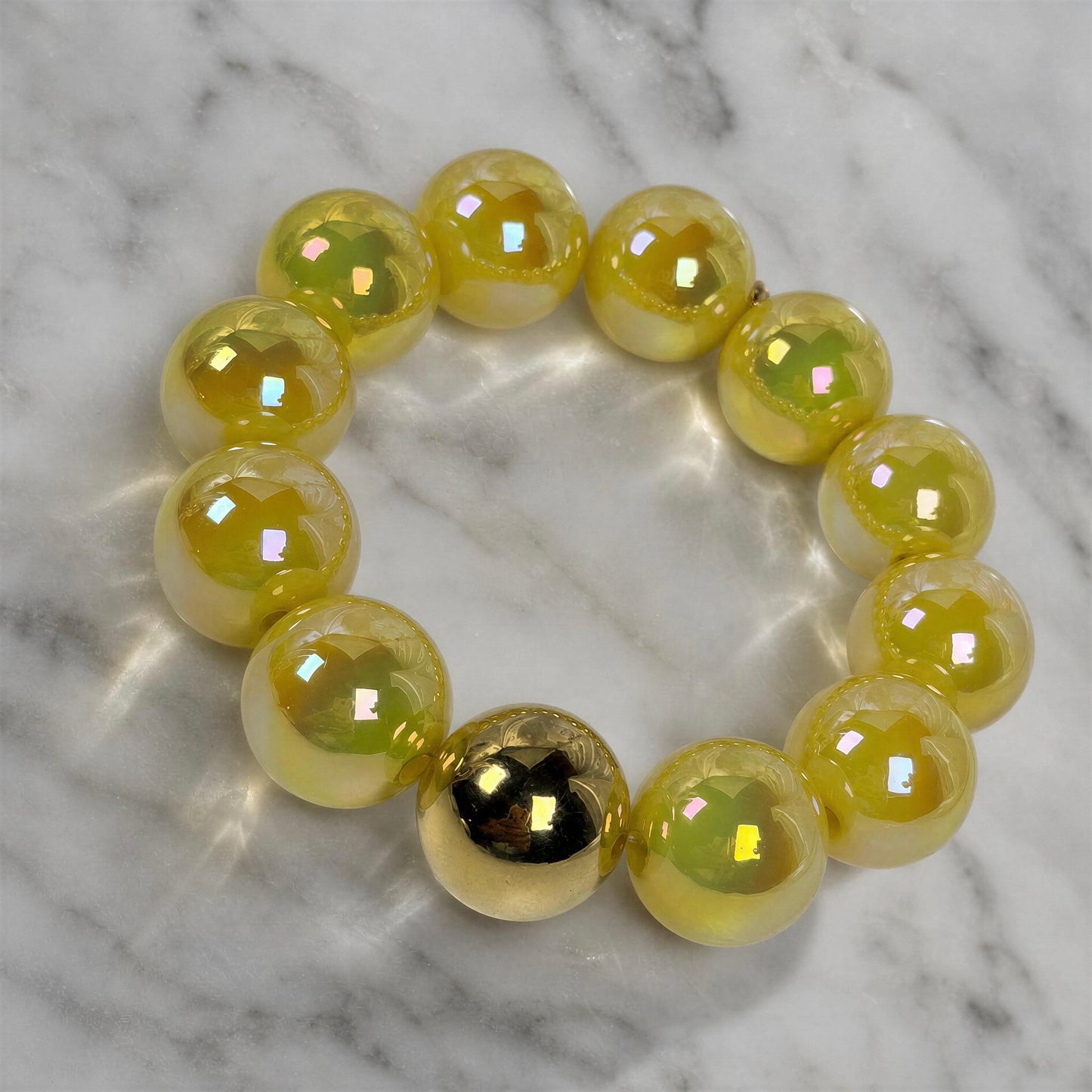 The Banana Glow Bracelet on a marble surface