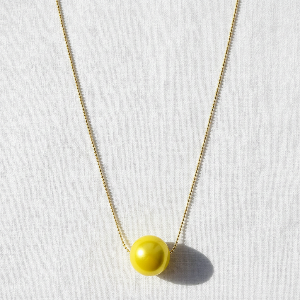 The Canary Yellow Petite Sphere Necklace - yellow pendant on a white background