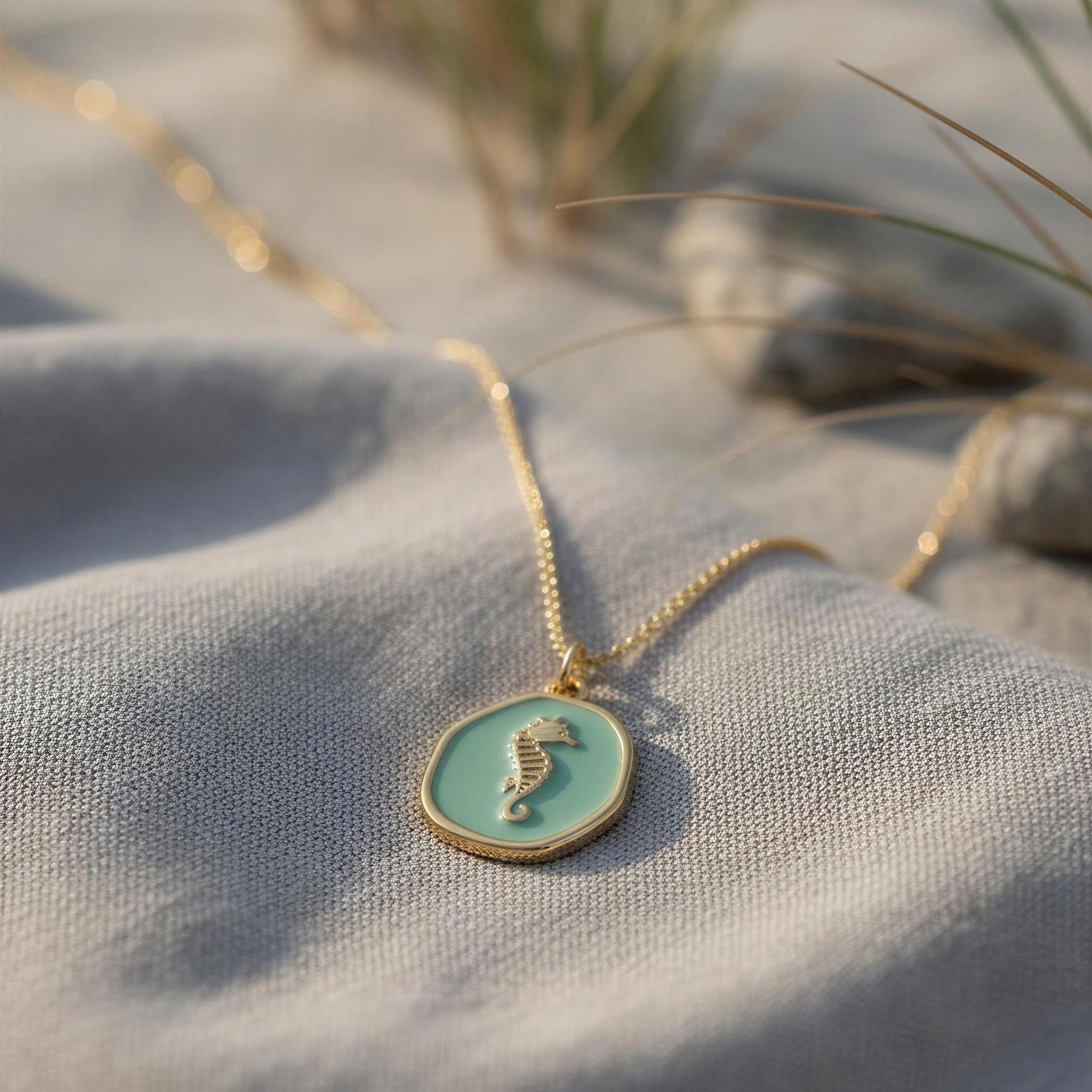 Necklace with a seahorse pendant on a textured surface