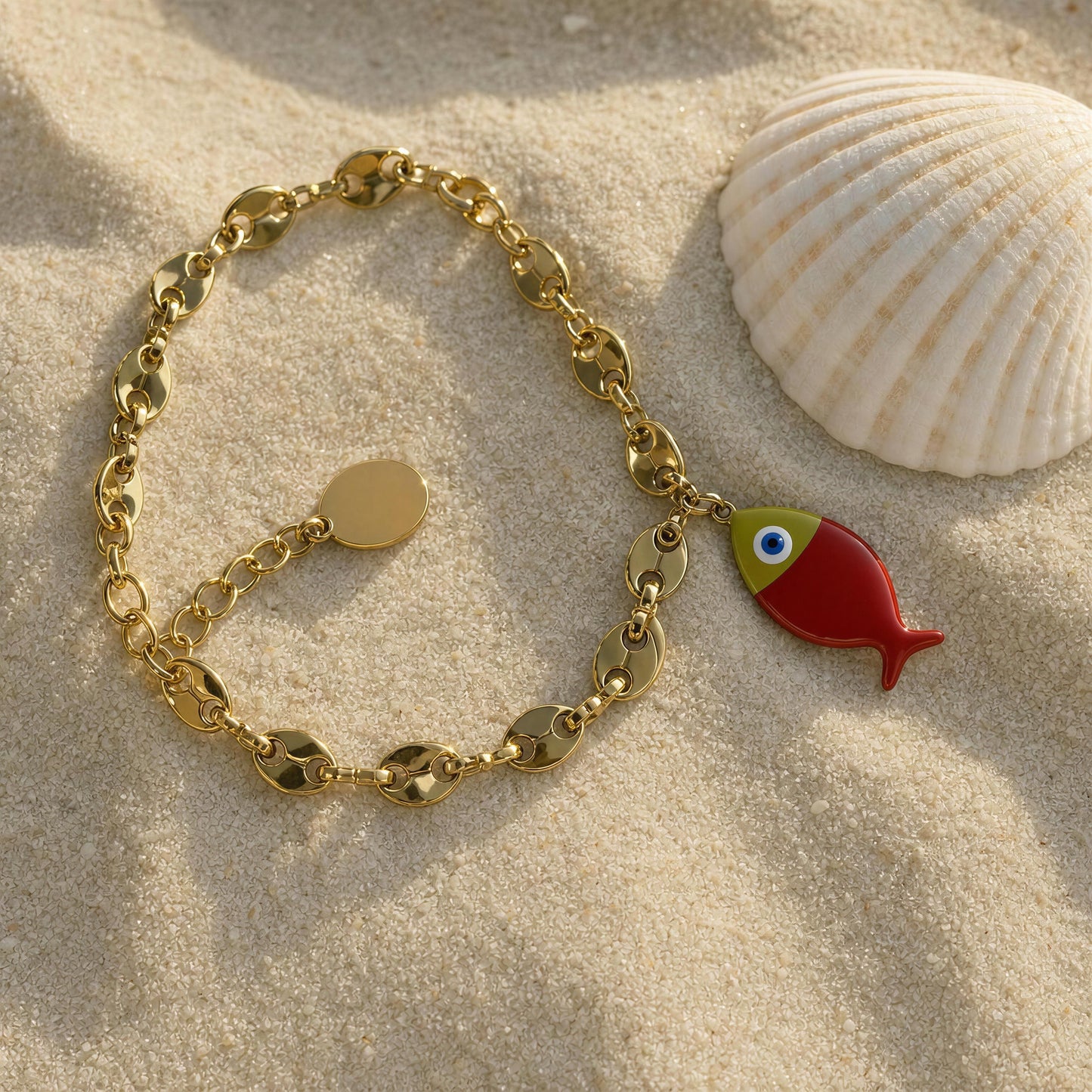 The Pesca Roja Bracelet on sand next to a shell