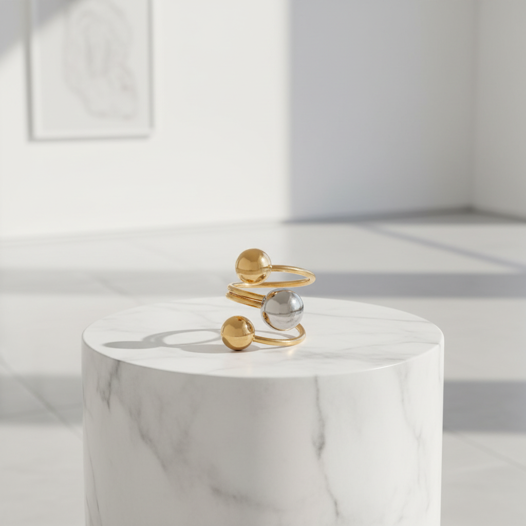 Celestial_Balance_Ring from Chica_Chica_Jewelry ring on a white marble pedestal with a neutral background