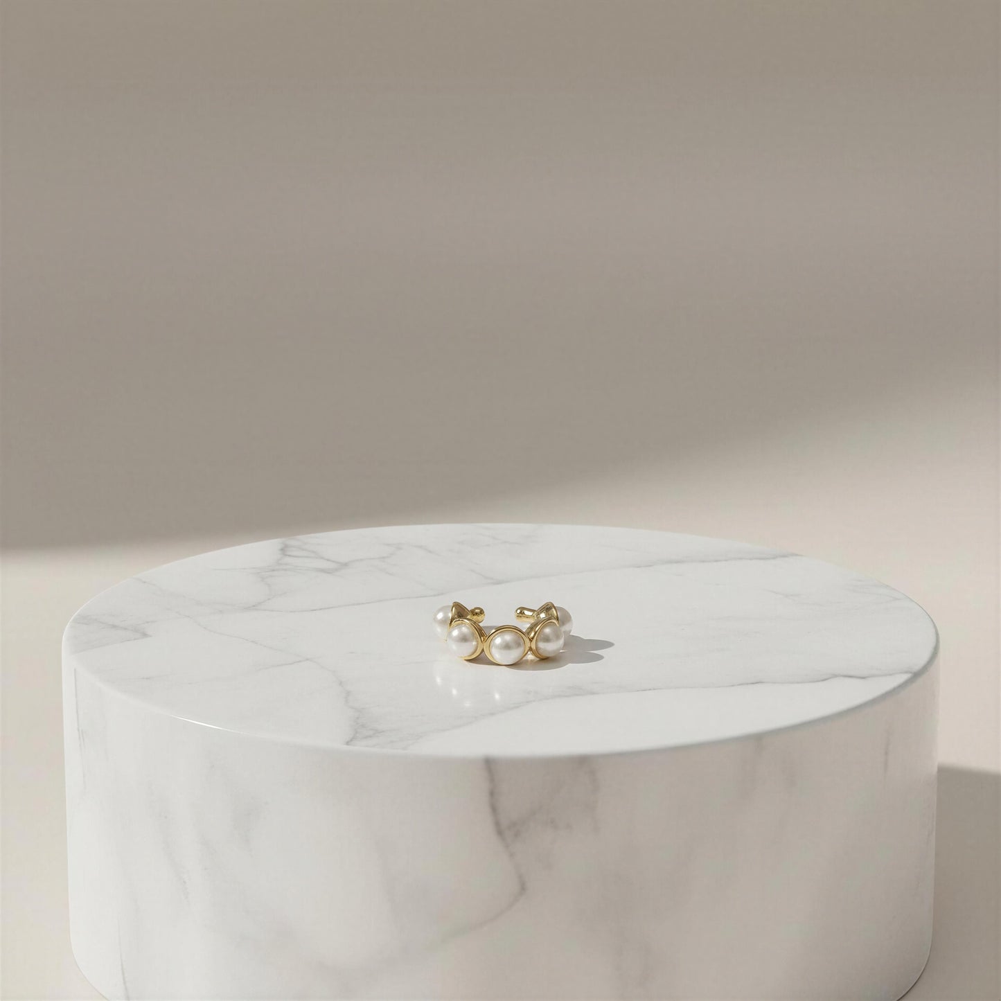 The Celestial Pearl Cuff on a marble surface with a neutral background