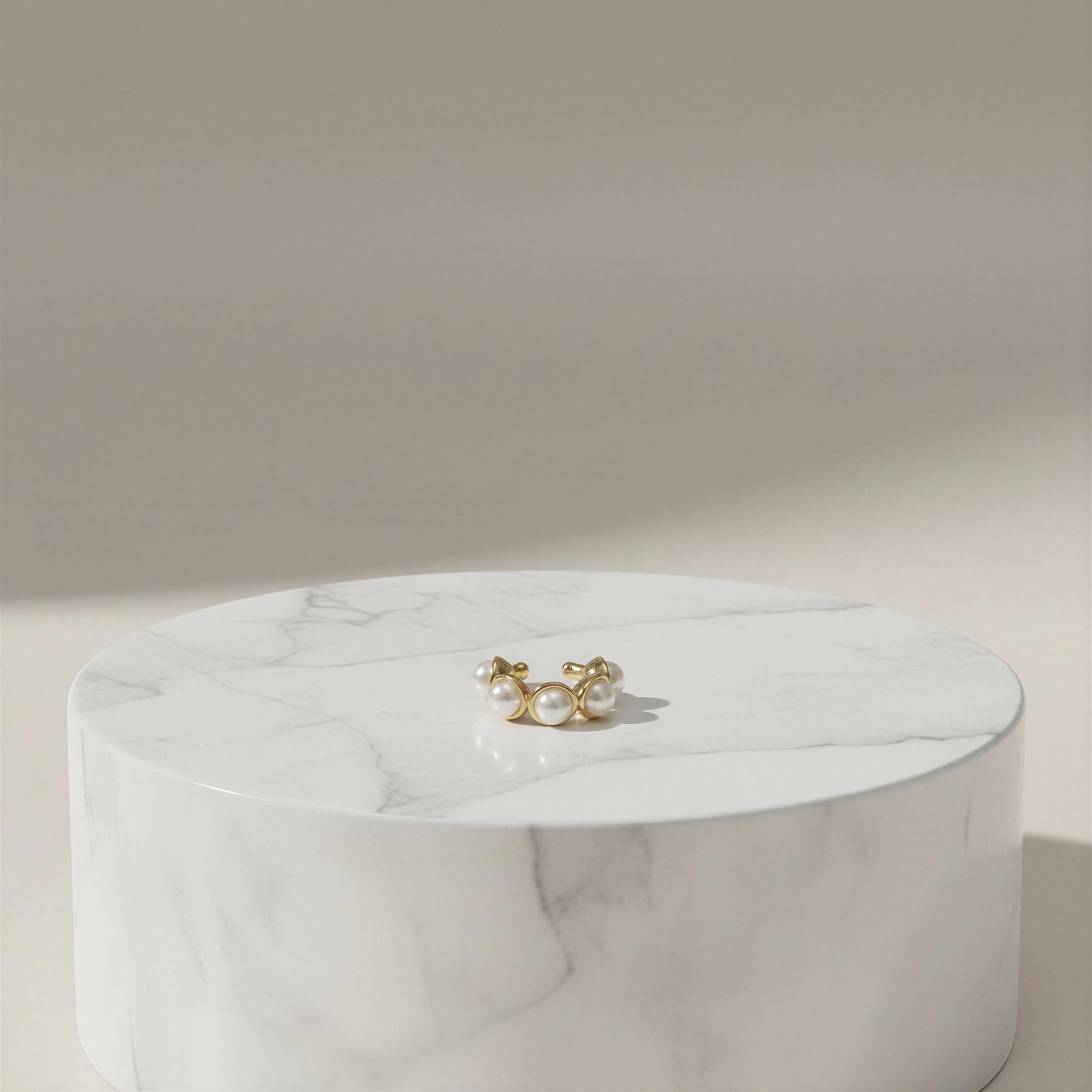 The Celestial Pearl Cuff on a marble surface with a neutral background
