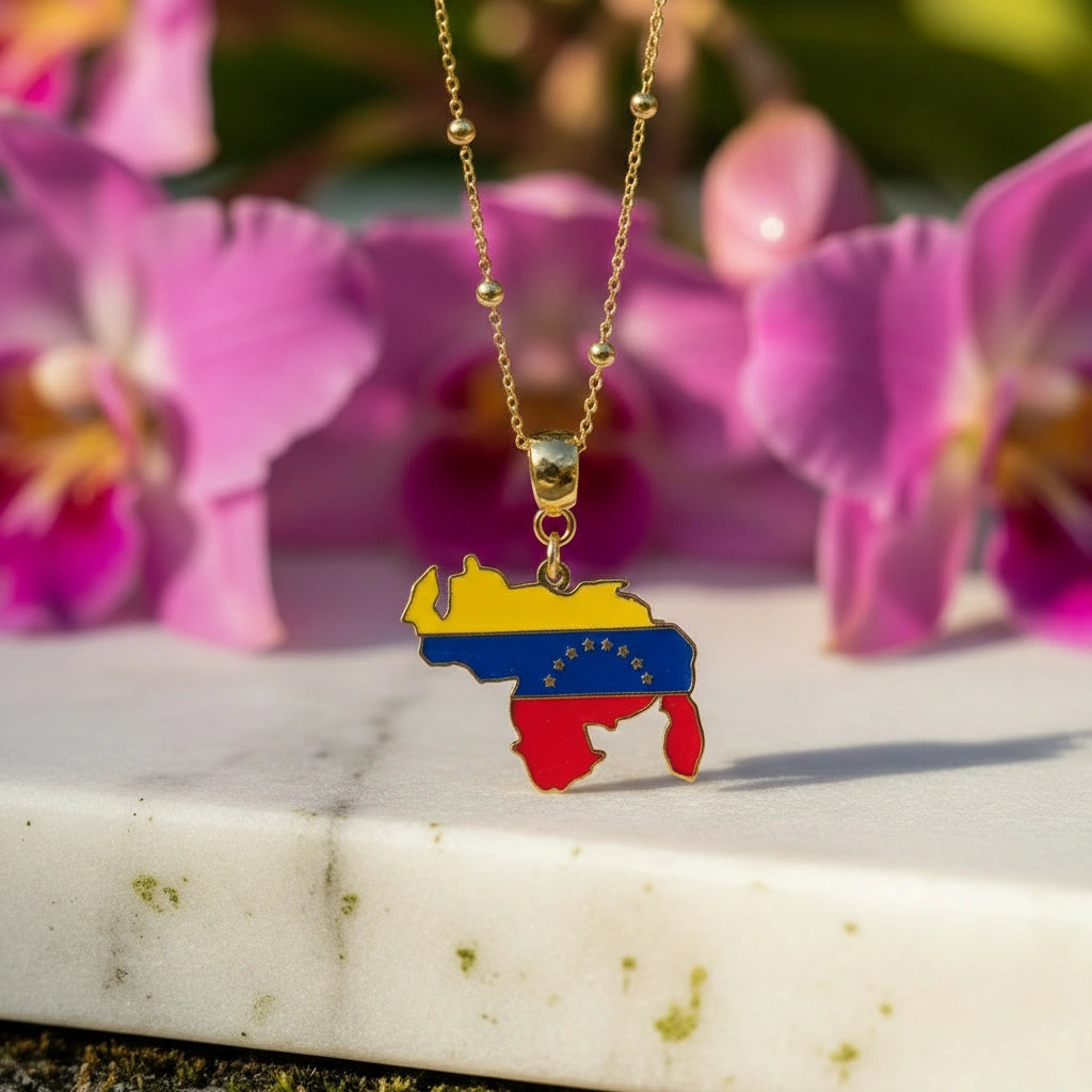 Necklace with a Venezuela map pendant against a background of pink flowers