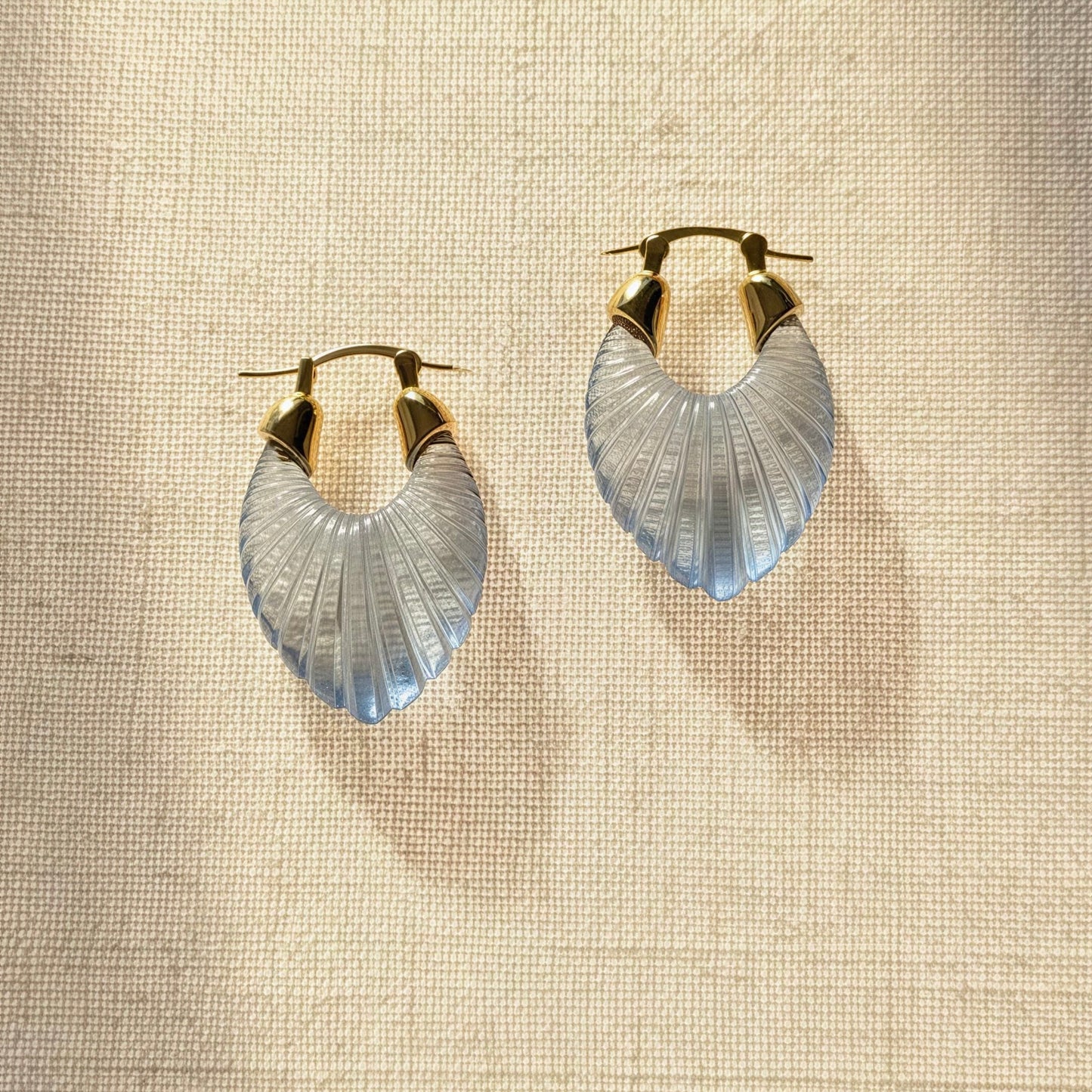 The Chica Chica Jewelry Celeste Earrings against linen fabric. 