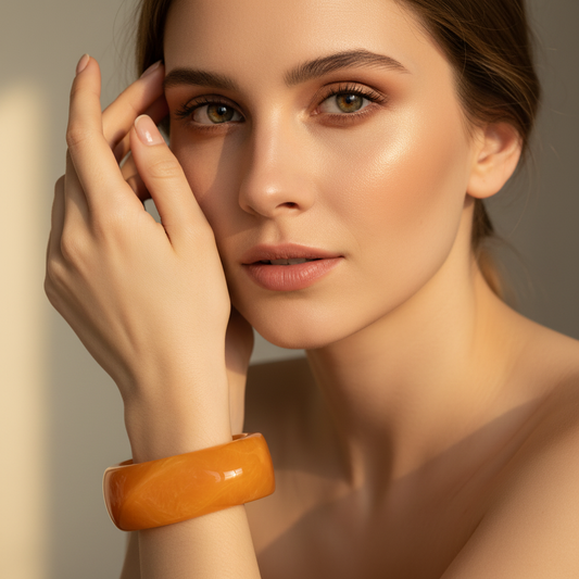Woman wearing the Amber Glow Bangle with a neutral background