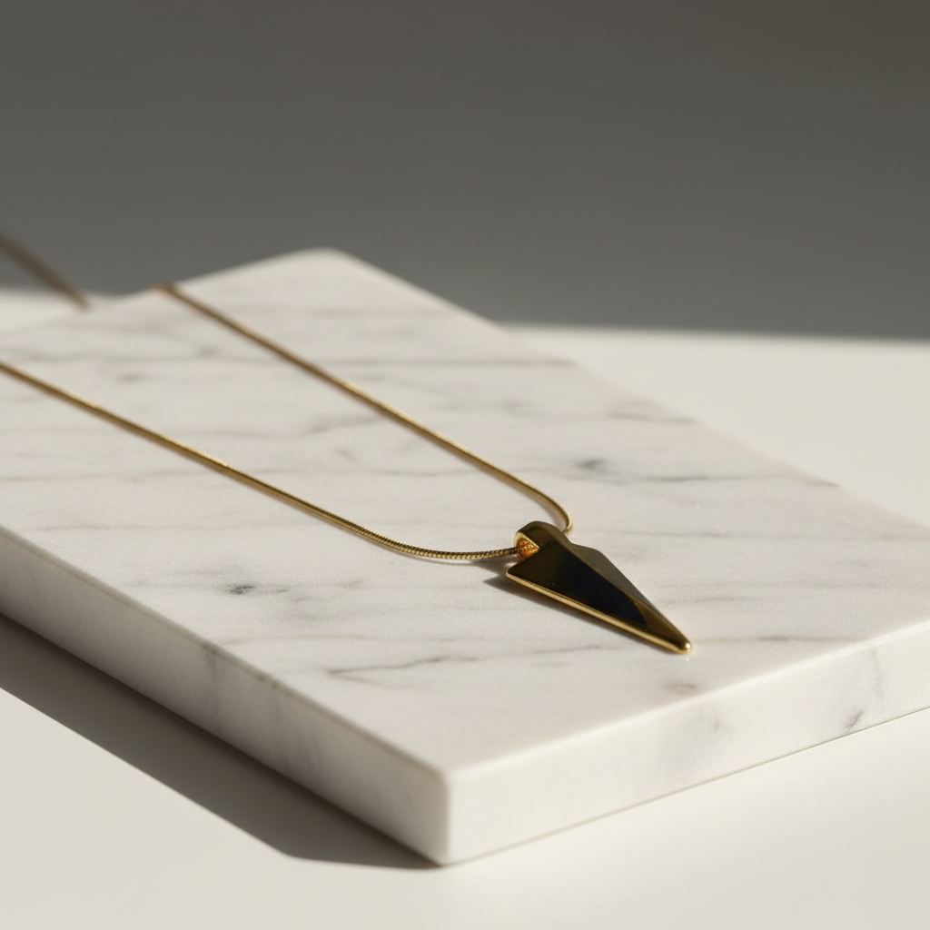 Axis Arrow Necklace on a marble surface