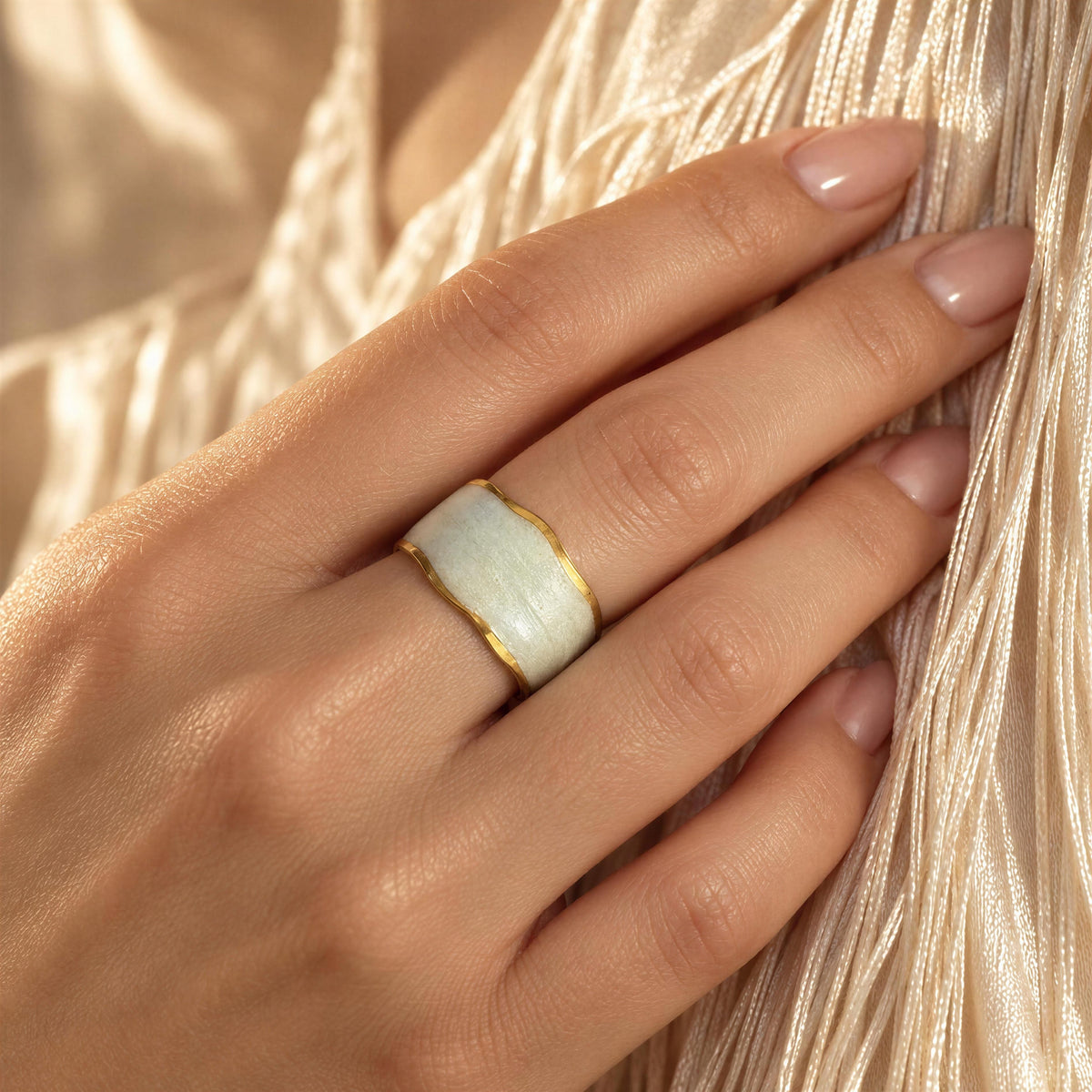 The Chica Chica Jewelry- Duna Ring - Alabastro against a crème color silk fringes dress.