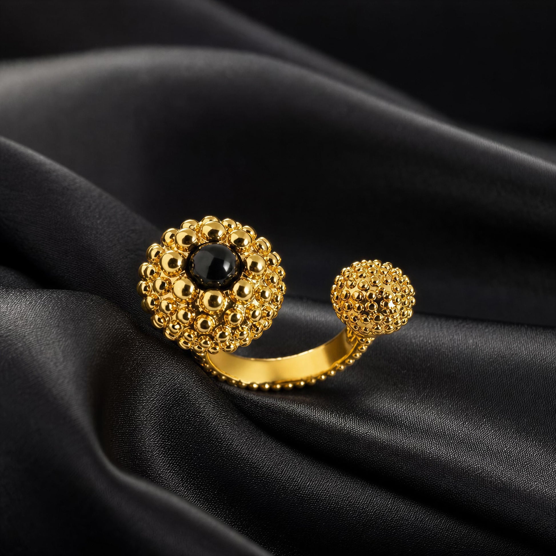 The Chica Chica Jewelry  - Nero Ring - gold with black agate stone, displayed on draped black satin fabric.