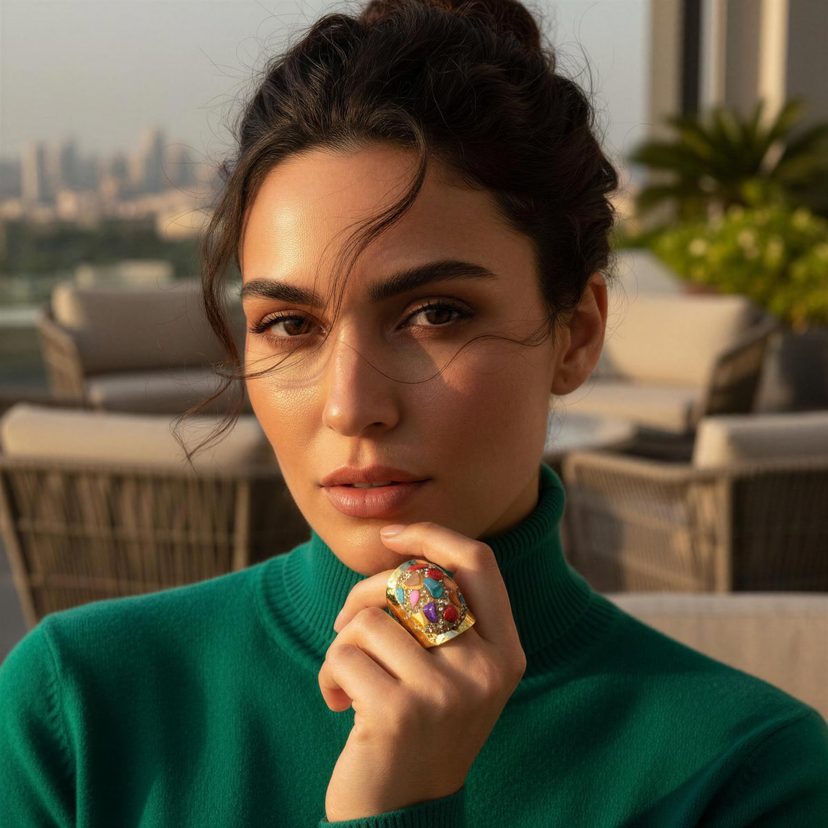 Model wearing the Chroma Ring from Chica Chica Jewelry and a green cashmere turtleneck.