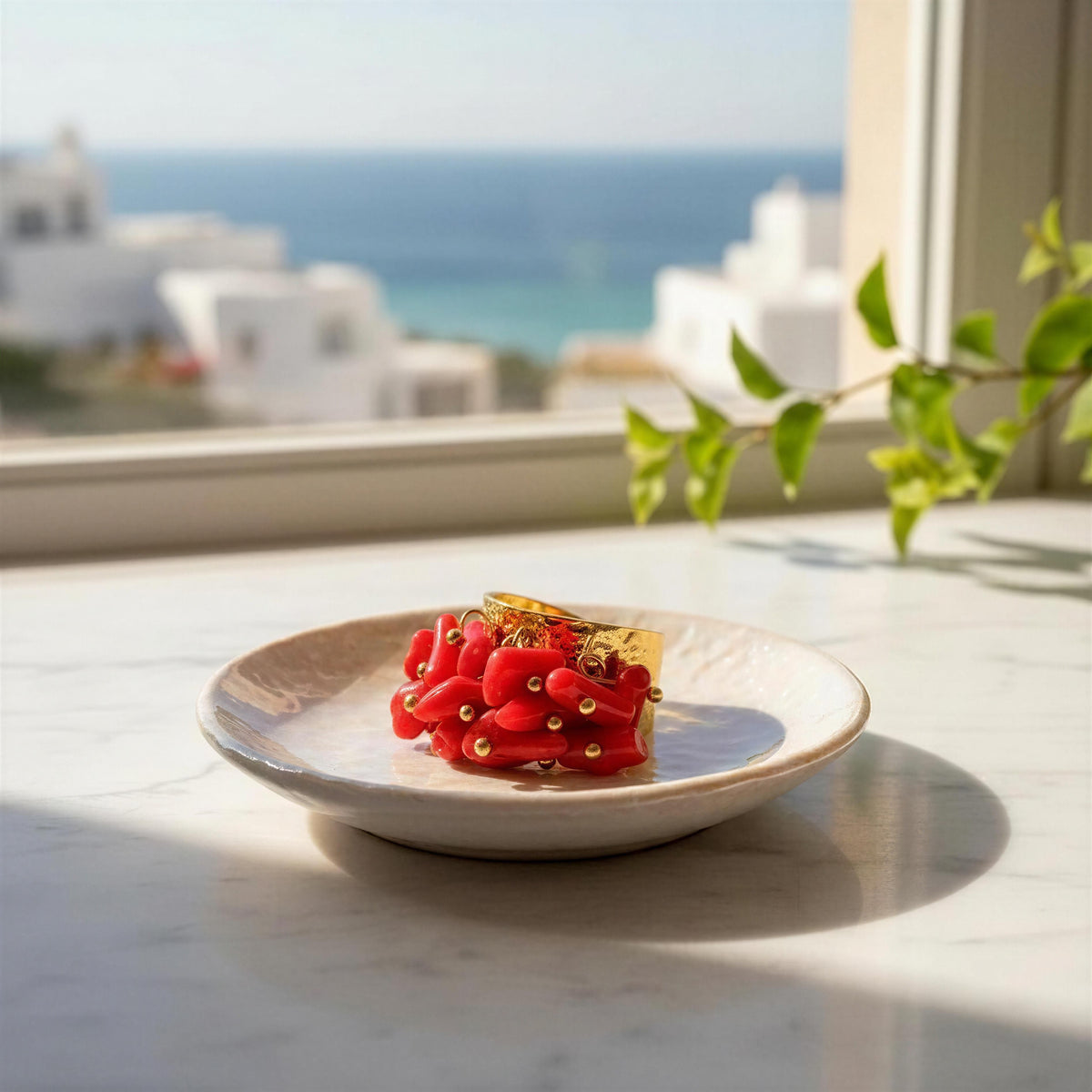 The Coral Ember Ring from Chica Chica Jewelry on a white dish by Mediterranean 