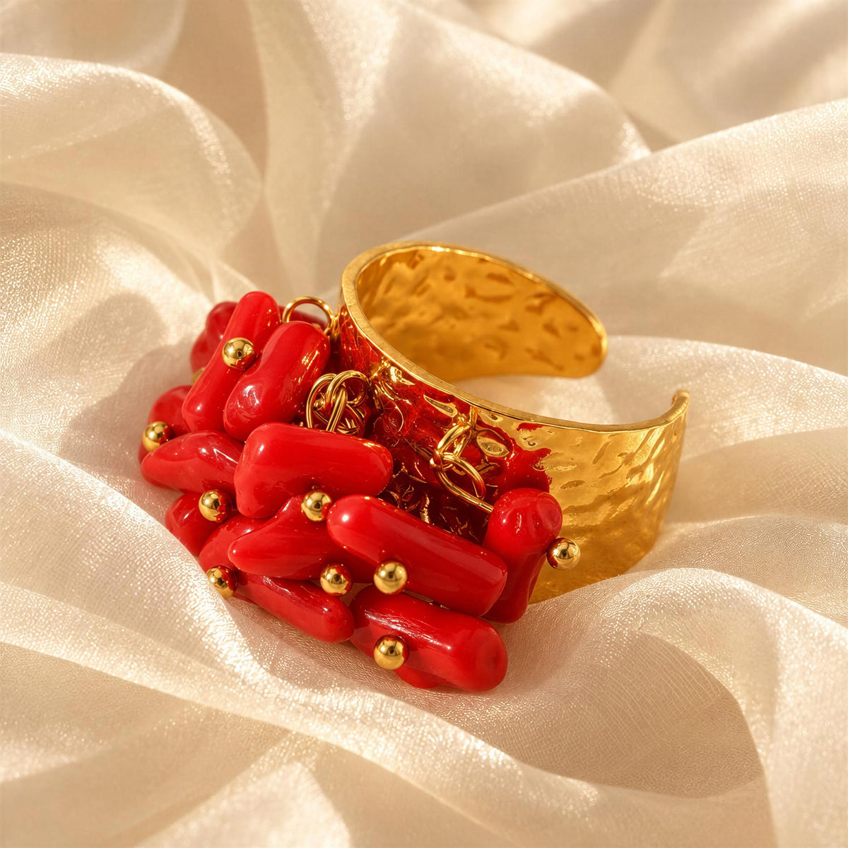 The Coral Ember Ring from Chica Chica Jewelry against ivory organza fabric 