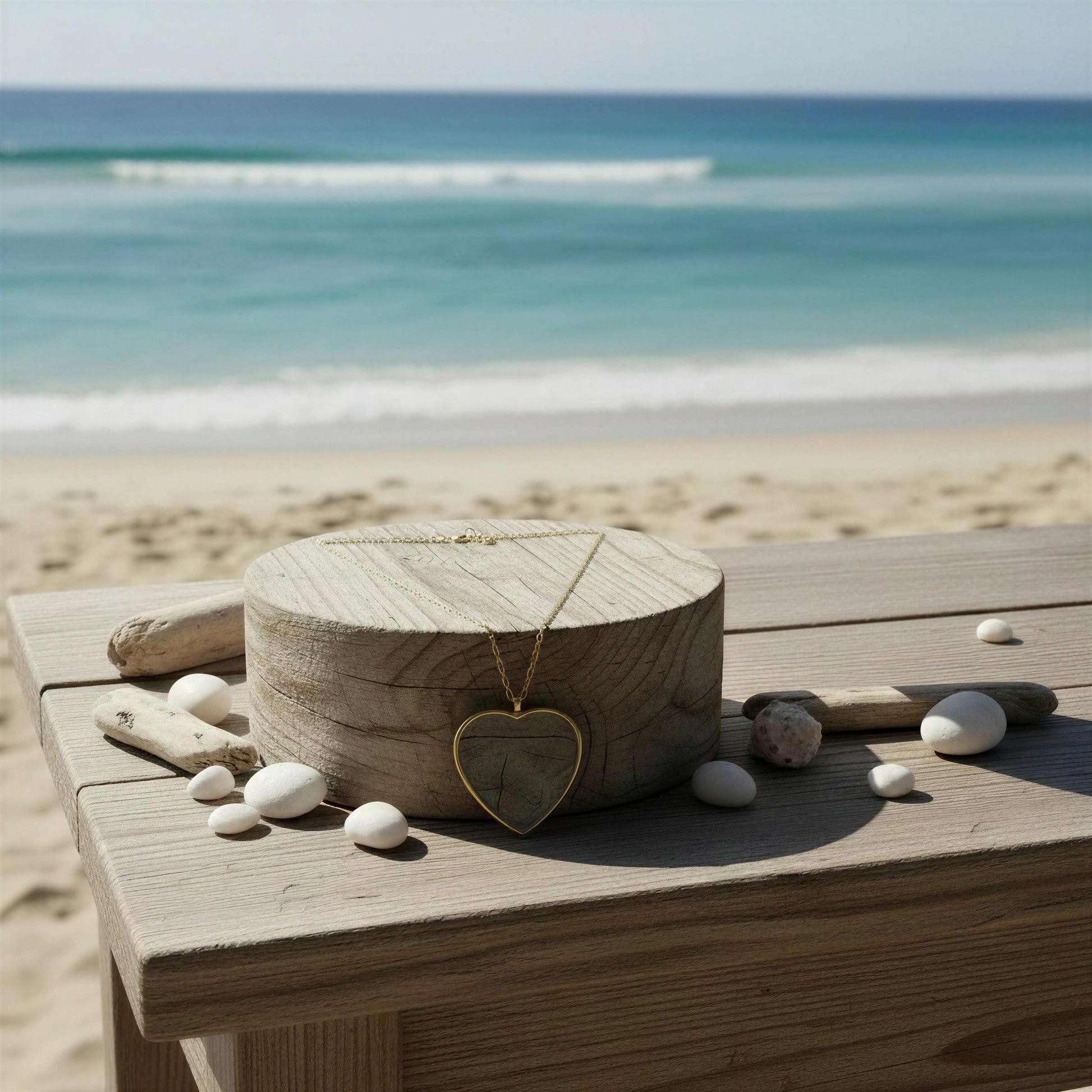 Wooden box with the Cristallo Heart Necklace  on a wooden surface by the beach.