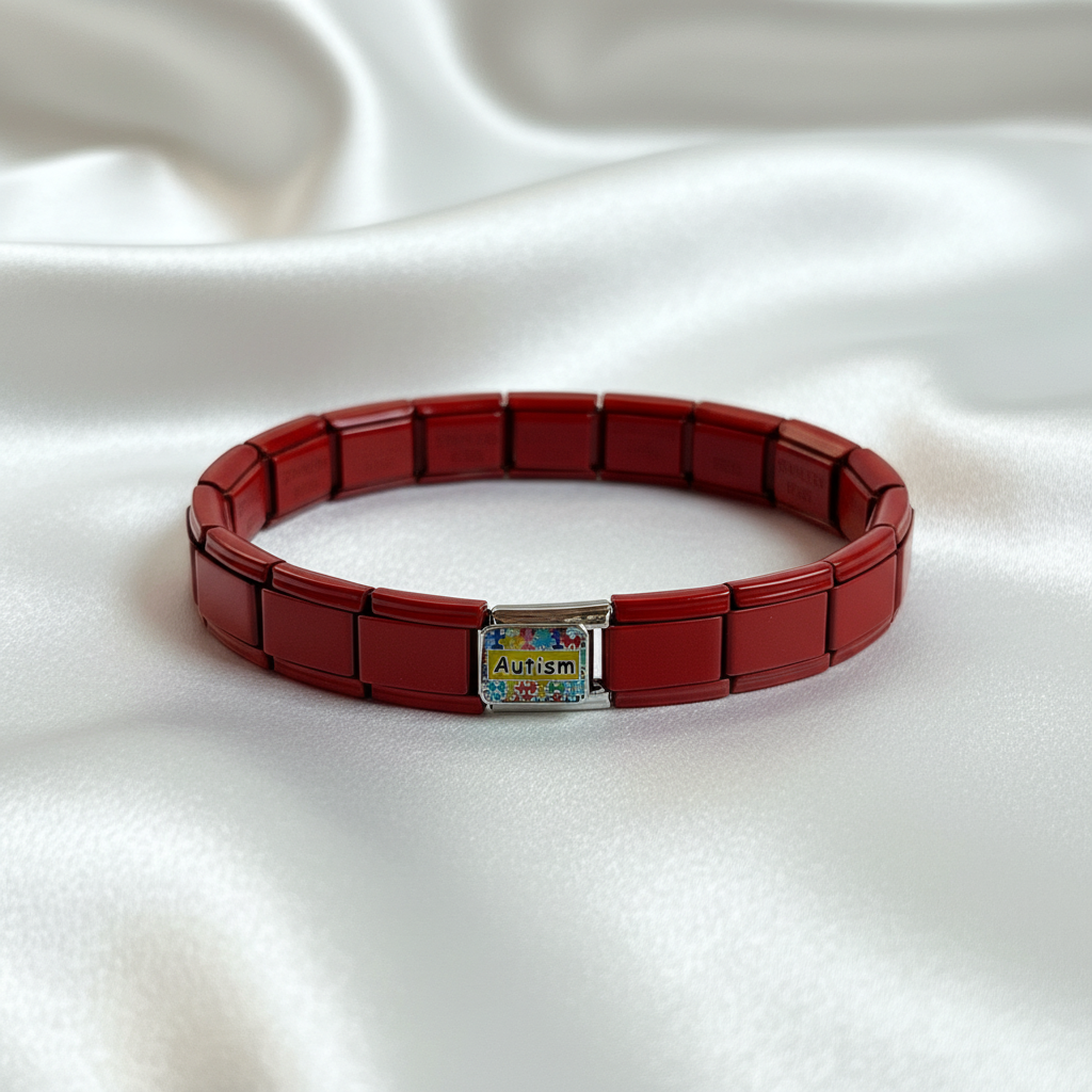 Red Italian stainless steel expandable bracelet with autism awareness charm displayed on white silk background
