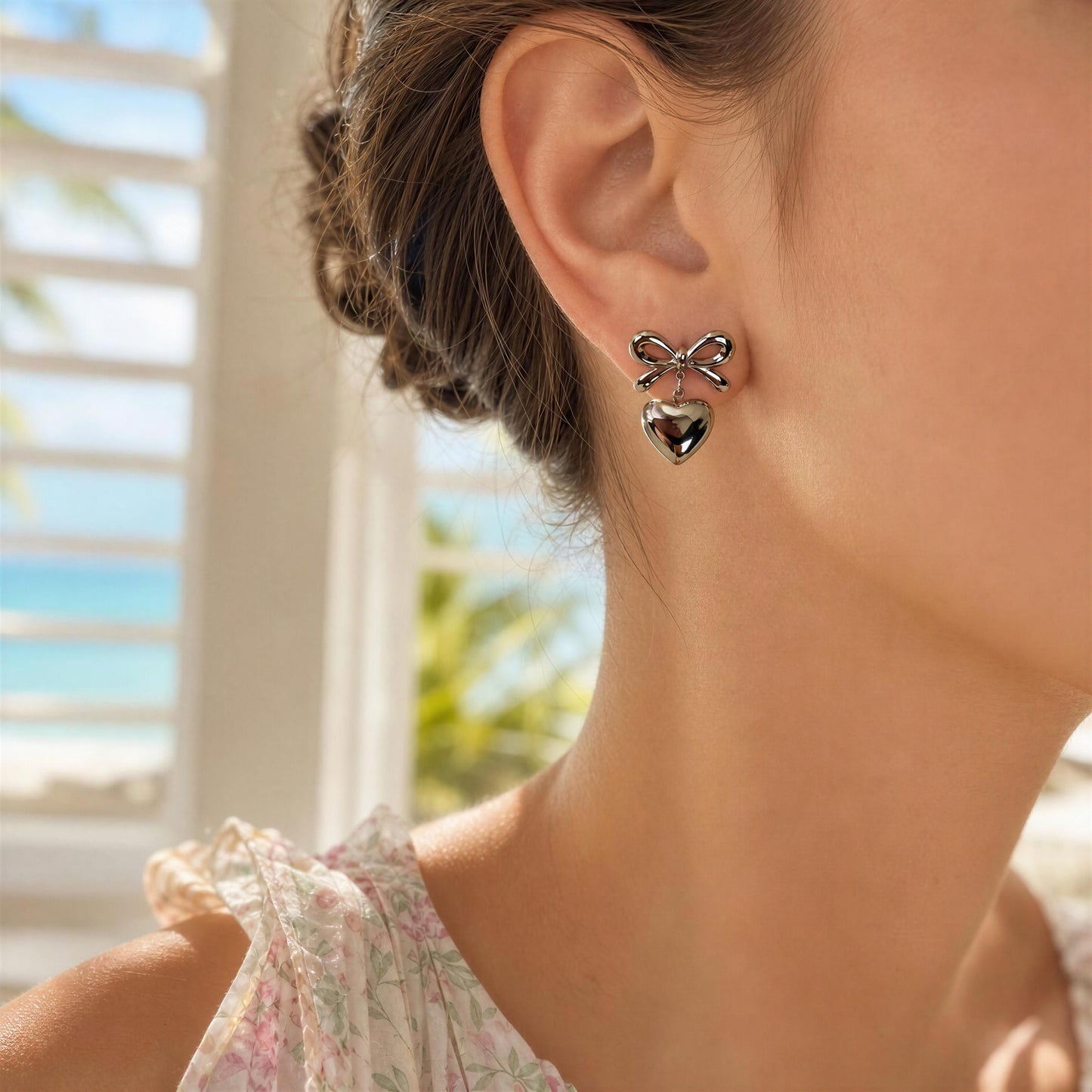Model wearing the Cupid's Knot Earrings - Silver at Caribbean indoors 
