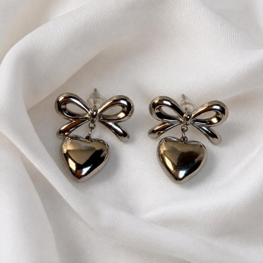 The Cupid's Knot Earrings - Silver against white fabric 