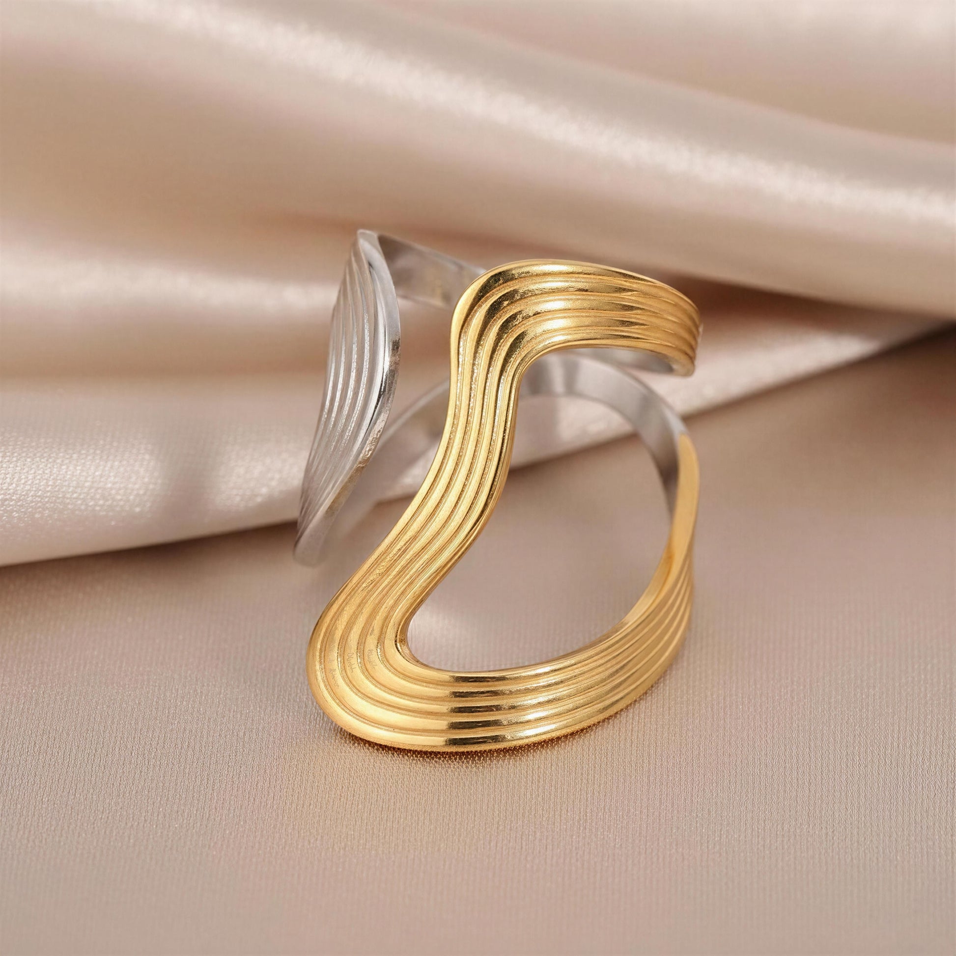 The  Dawn & Dusk Wave Ring  on a beige fabric background