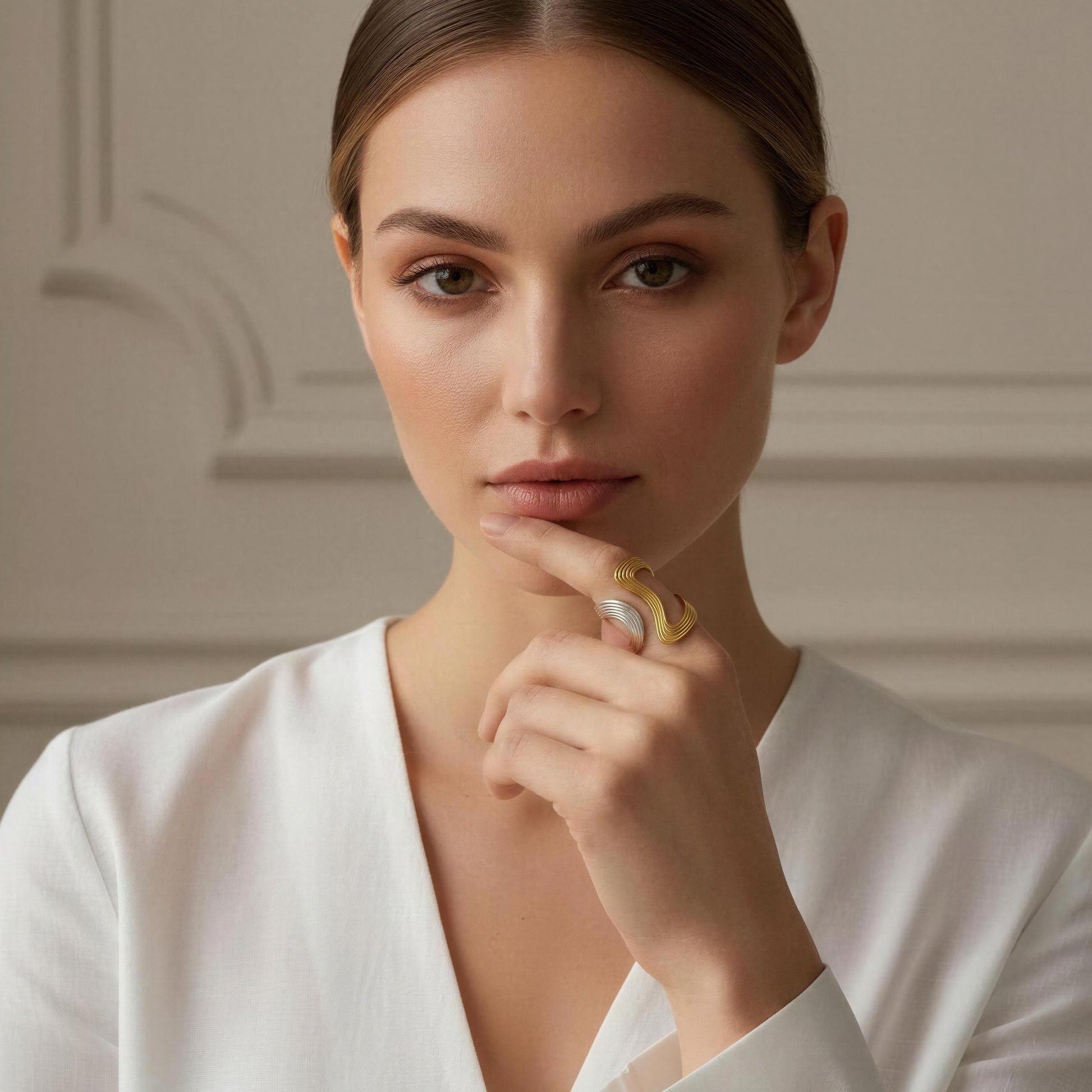 Woman wearing a white top and the Dawn & Dusk Wave Ring  with a neutral background 
