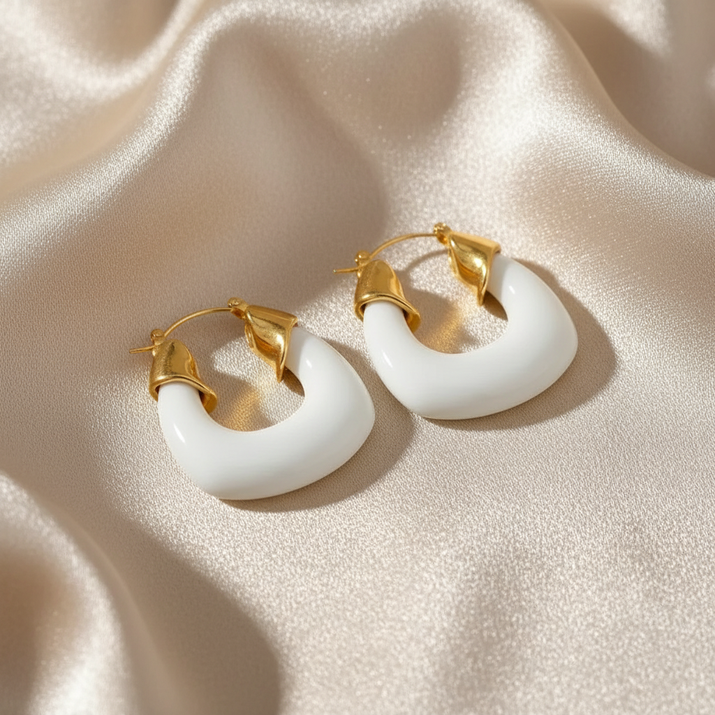 Pair of gold and white hoop earrings - Deco White Hoops - Chica Chica Jewelry on a beige fabric background
