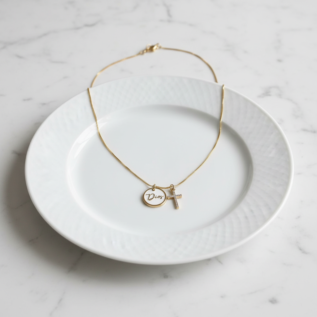 Gold necklace with a pendant on a white plate