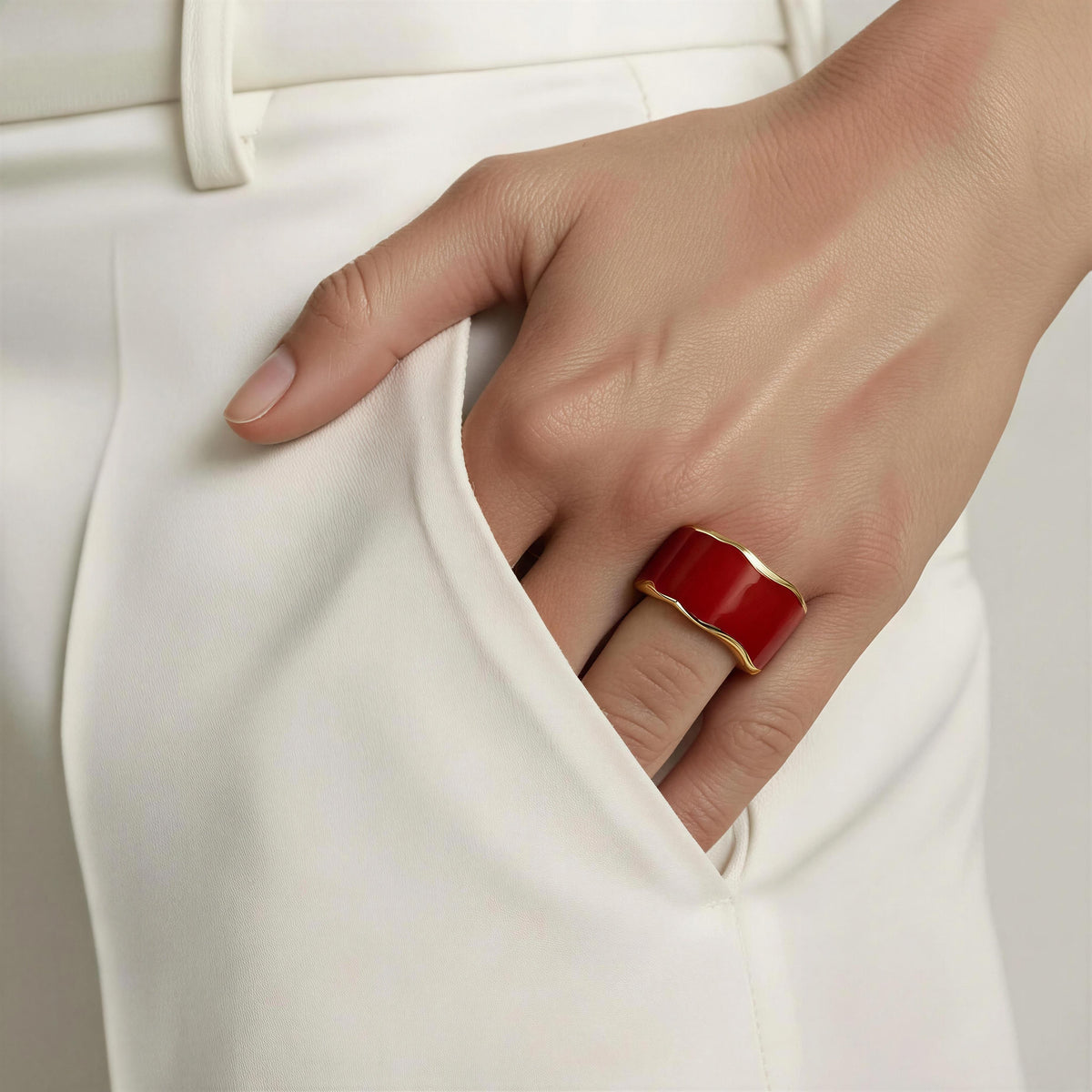 Model’s hand wearing white trousers and hand on pocket wearing the Duna Ring – Carmine from Chica Chica Jewelry 