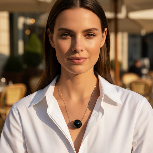 Woman wearing a white shirt with a blurred outdoor background