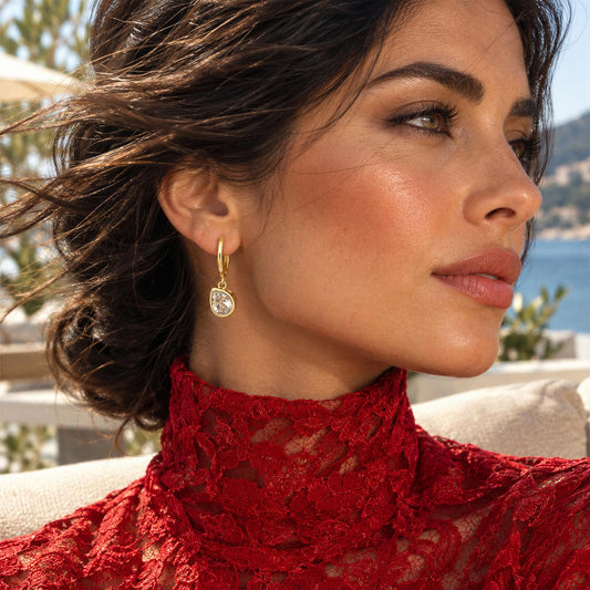 Model wearing a red turtleneck lace couture dress and the Elara Huggies from Chica Chica Jewelry.