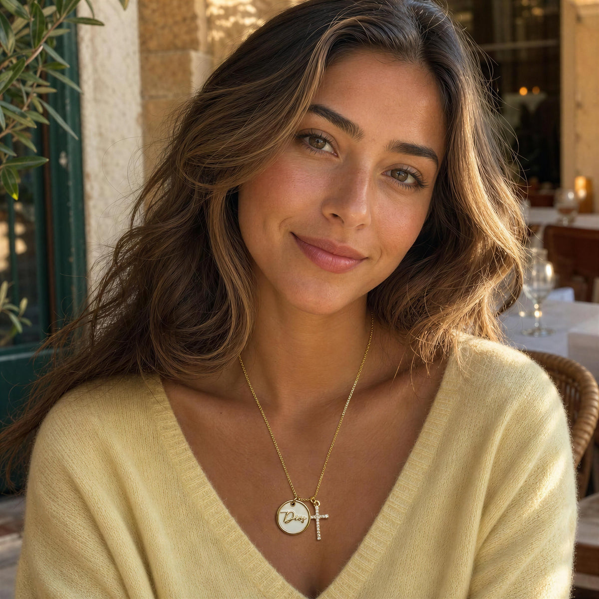 Model wearing the Grazia Necklace from Chica Chica Jewelry and a butter yellow cashmere sweater. 
