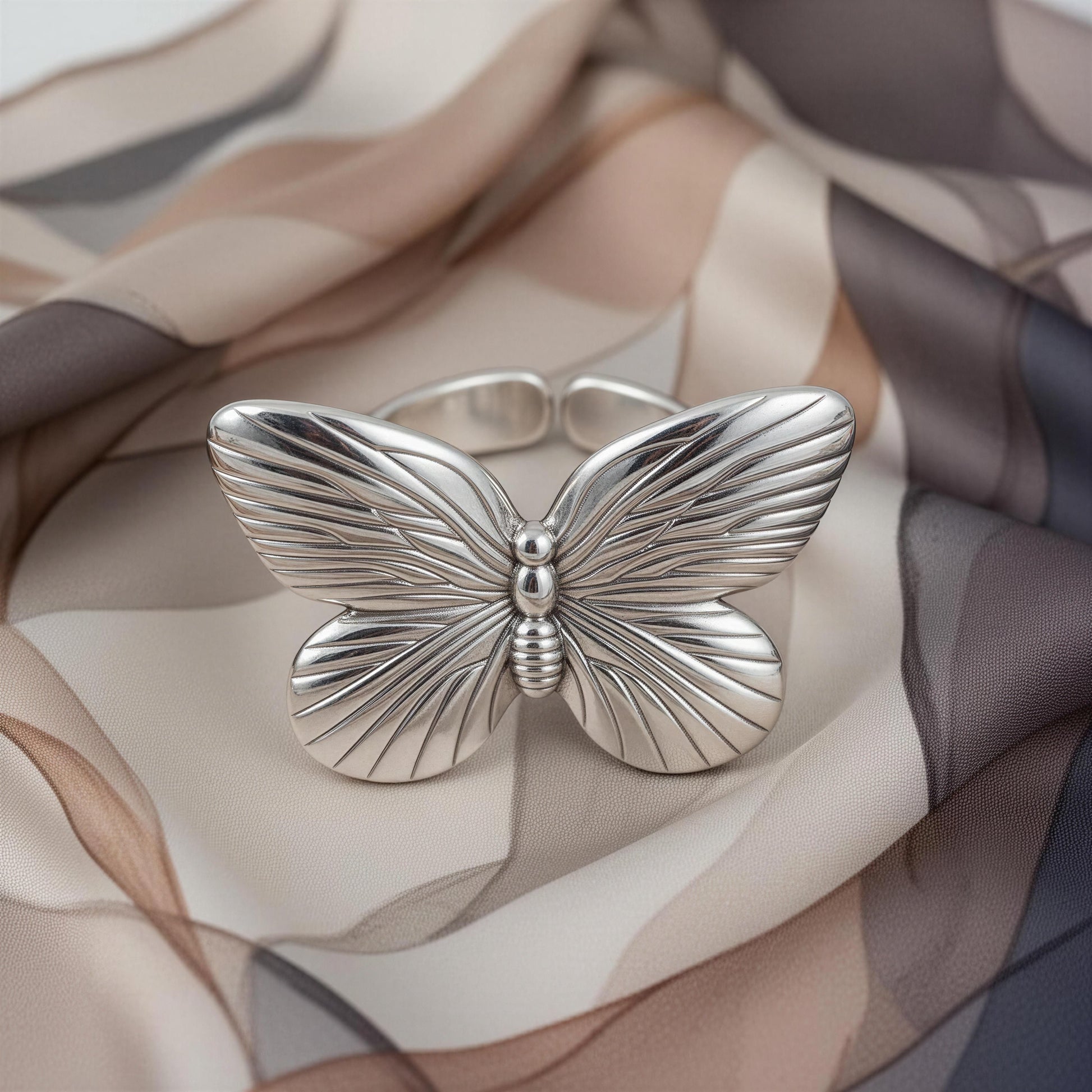 The Forever Flutter Ring in Silver on a soft fabric background