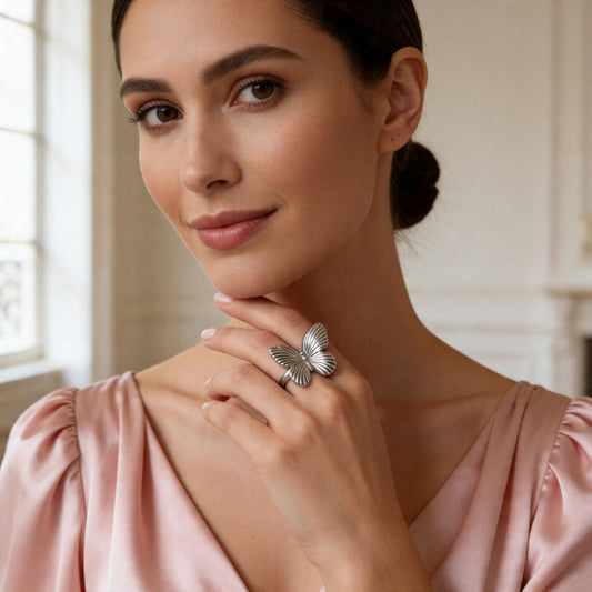 Woman wearing the Forever Flutter Ring  – Silver in a softly lit room
