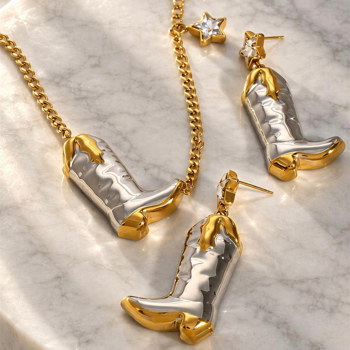 The Frontier Boot Jewelry Set- from Chica Chica Jewelry against a marble table.