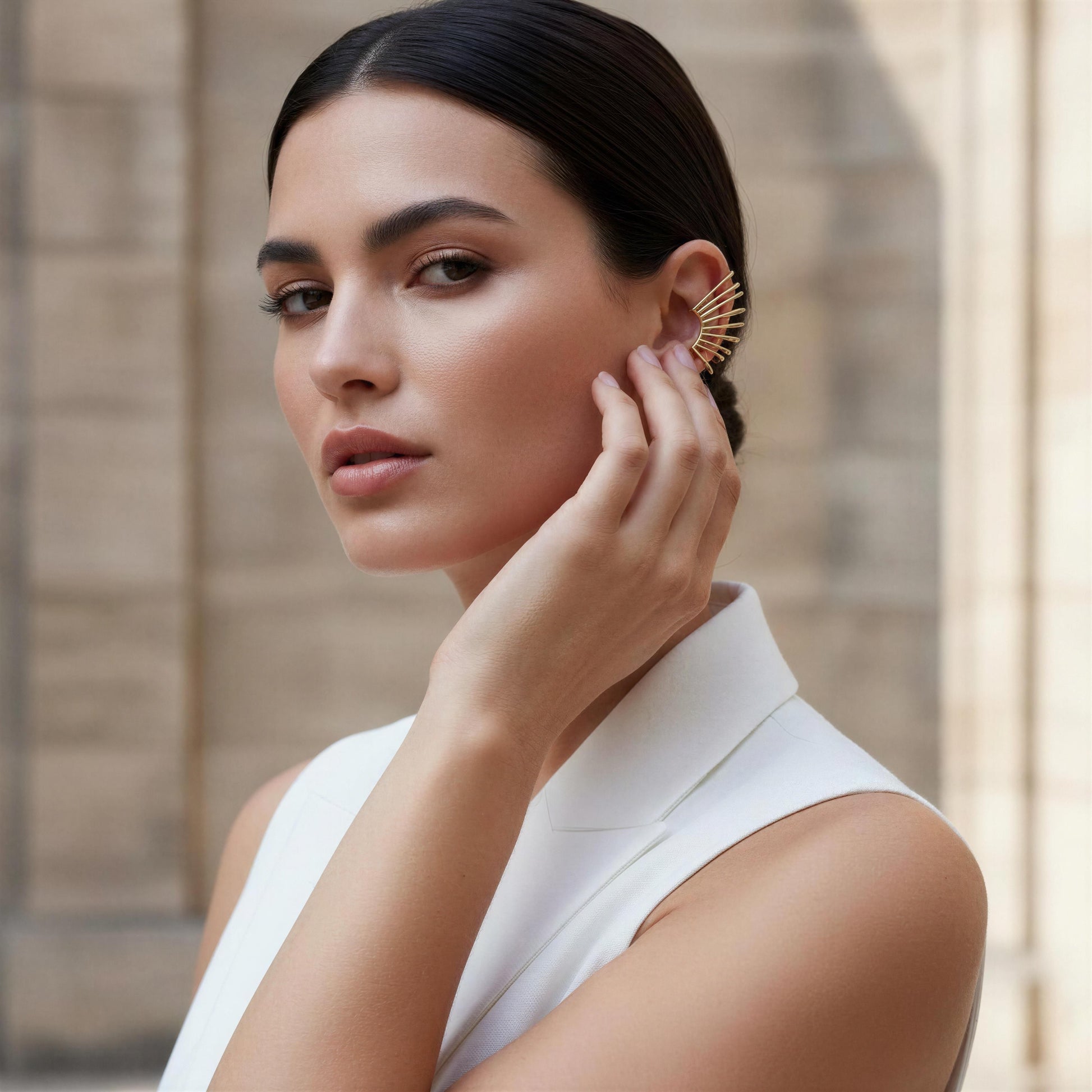 Woman wearing the Golden Horizon Ear Cuff in a neutral background