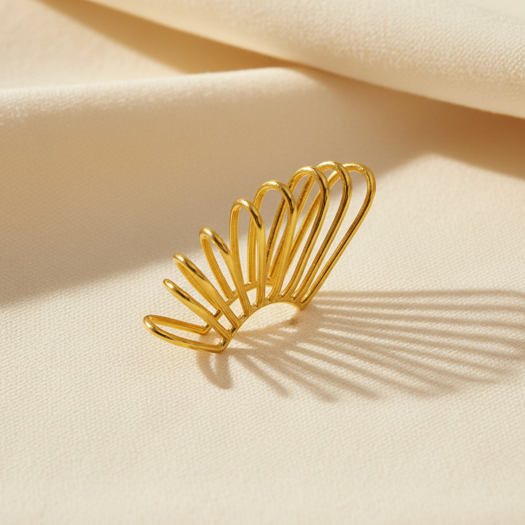 Golden Horizon Ear Cuff on a beige fabric background