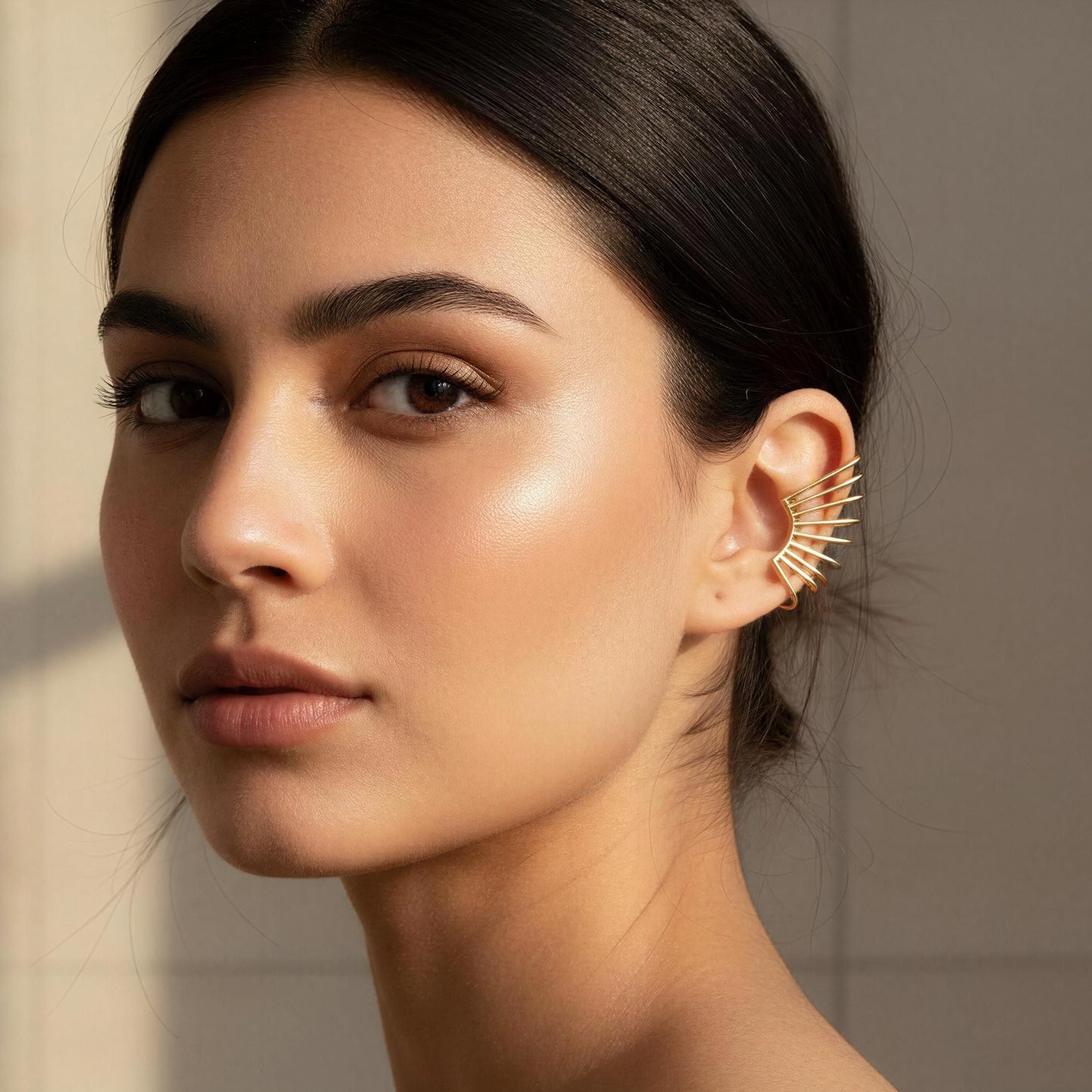 Woman wearing the Golden Horizon Ear Cuff against a neutral background