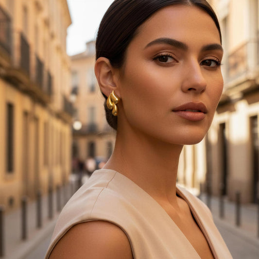 Woman with gold earrings standing on a city street