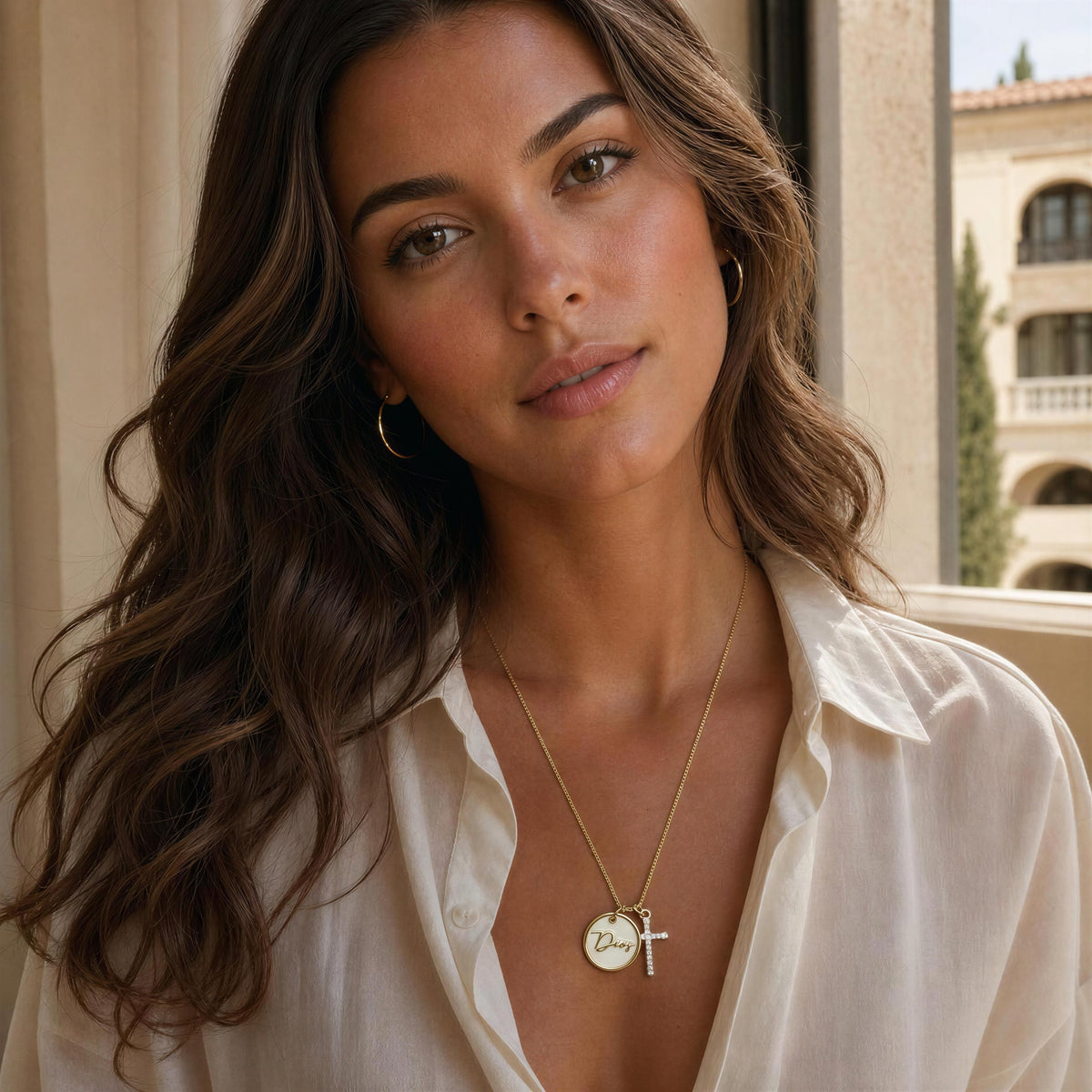 Model wearing the Grazia Necklace- Chica Chica Jewelry by Mediterranean indoor window.