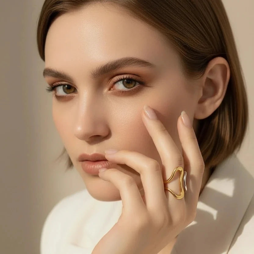 Woman wearing a gold ring with a beige background